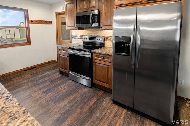 511 E Wilson St, Beckemeyer, IL 62219 - kitchen featuring stainless steel appliances, decorative backsplash, dark wood-style floors, light stone countertops, and baseboards