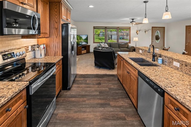 511 E Wilson St, Beckemeyer, IL 62219 - kitchen featuring appliances with stainless steel finishes, a sink, brown cabinetry, a ceiling fan, and dark wood-type flooring