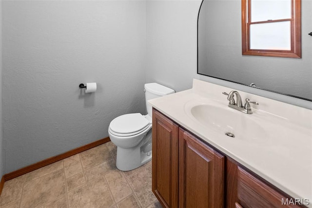 511 E Wilson St, Beckemeyer, IL 62219 - bathroom with baseboards, toilet, vanity, and a textured wall