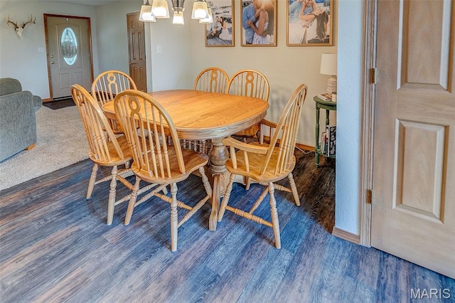 511 E Wilson St, Beckemeyer, IL 62219 - dining room with wood finished floors, a chandelier, and baseboards