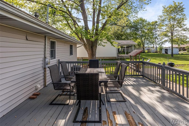 511 E Wilson St, Beckemeyer, IL 62219 - wooden terrace with outdoor dining area and a lawn