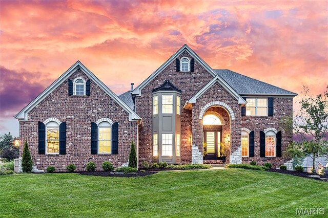 5316 Enchanted Ct, Weldon Spring, MO 63304 - view of front of home with brick siding, a lawn, and a shingled roof