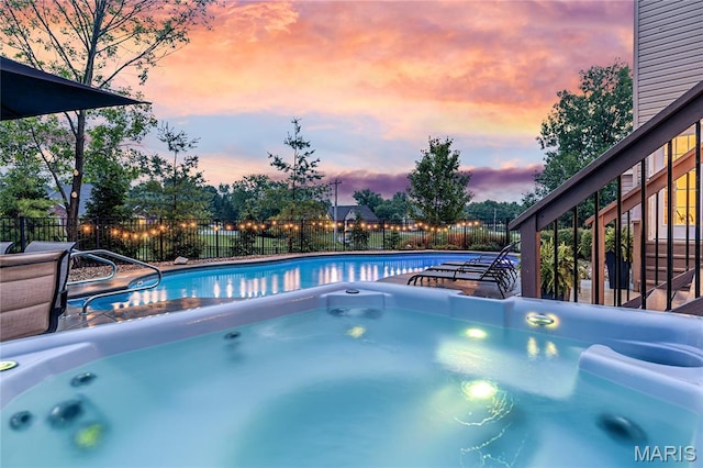 5316 Enchanted Ct, Weldon Spring, MO 63304 - pool at dusk with a hot tub