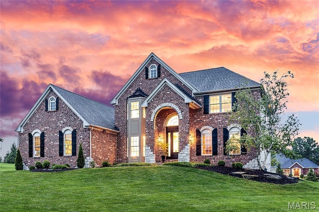 5316 Enchanted Ct, Weldon Spring, MO 63304 - view of front of house with brick siding, a lawn, and roof with shingles