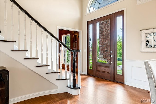 5316 Enchanted Ct, Weldon Spring, MO 63304 - entryway featuring wood finished floors, stairs, and a wainscoted wall