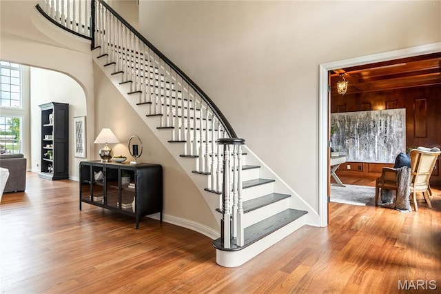 5316 Enchanted Ct, Weldon Spring, MO 63304 - stairs with wood finished floors, a high ceiling, and arched walkways