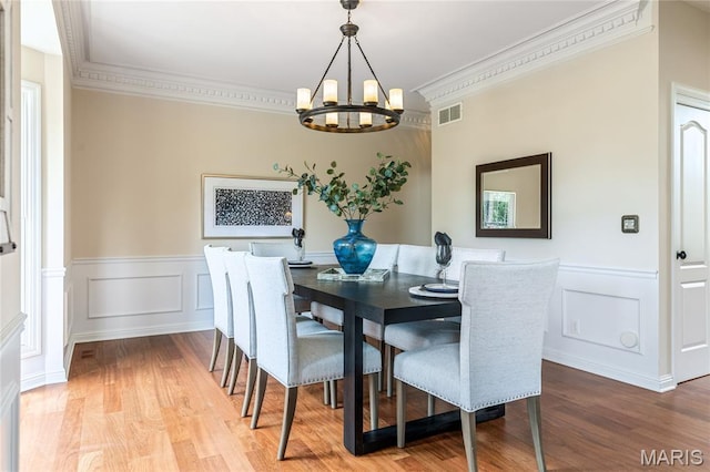 5316 Enchanted Ct, Weldon Spring, MO 63304 - dining room with a chandelier, crown molding, wood finished floors, wainscoting, and a decorative wall