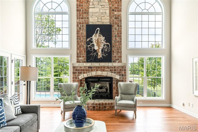 5316 Enchanted Ct, Weldon Spring, MO 63304 - living area with a fireplace, a high ceiling, and wood finished floors