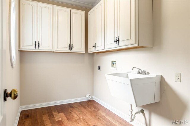 5316 Enchanted Ct, Weldon Spring, MO 63304 - laundry area with hookup for an electric dryer, hookup for a washing machine, wood finished floors, and cabinet space