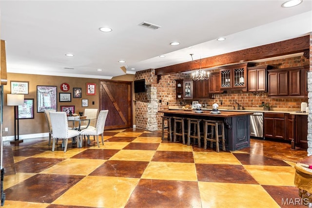 5316 Enchanted Ct, Weldon Spring, MO 63304 - kitchen featuring a breakfast bar area, stainless steel dishwasher, recessed lighting, glass insert cabinets, and decorative light fixtures