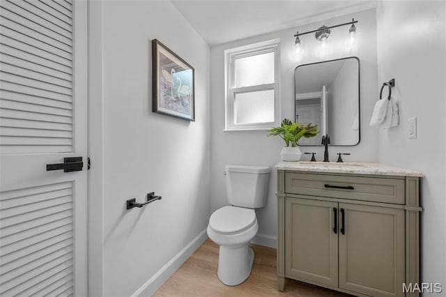 2736 Ashrock Dr, Saint Louis, MO 63129 - bathroom with toilet, vanity, wood finished floors, and baseboards