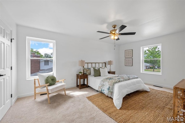 2736 Ashrock Dr, Saint Louis, MO 63129 - bedroom with multiple windows, baseboards, light colored carpet, and ceiling fan