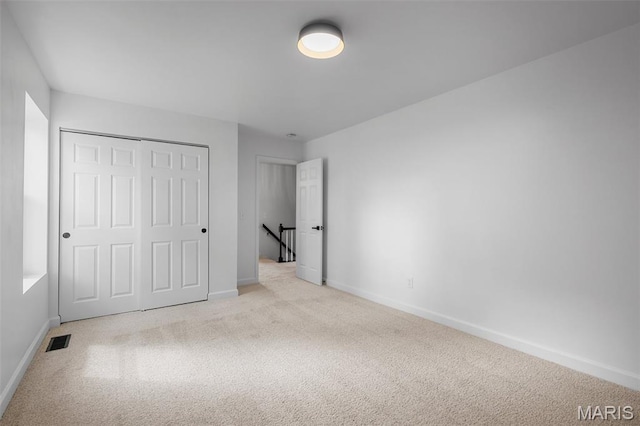 2736 Ashrock Dr, Saint Louis, MO 63129 - unfurnished bedroom featuring carpet floors, baseboards, and a closet