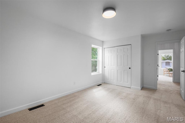 2736 Ashrock Dr, Saint Louis, MO 63129 - unfurnished bedroom with light carpet, baseboards, and a closet