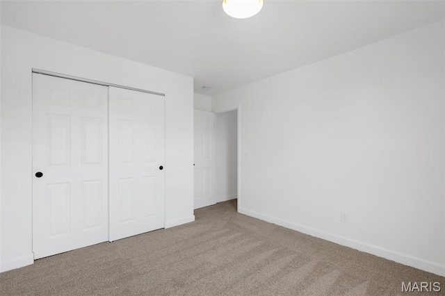 2736 Ashrock Dr, Saint Louis, MO 63129 - unfurnished bedroom featuring carpet, a closet, and baseboards