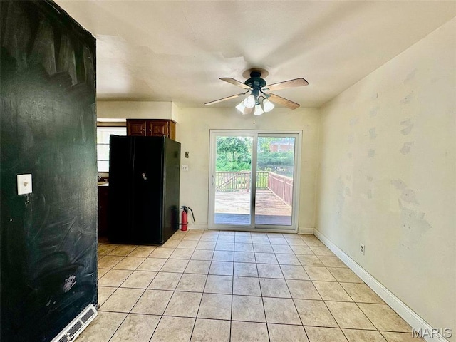 860 Chouteau Ave, Godfrey, IL 62035 - unfurnished room featuring ceiling fan, light tile patterned floors, and baseboards