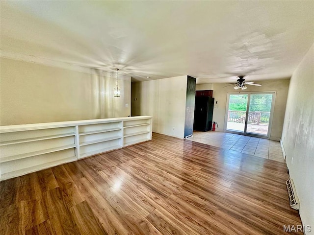 860 Chouteau Ave, Godfrey, IL 62035 - unfurnished living room with wood finished floors and a ceiling fan
