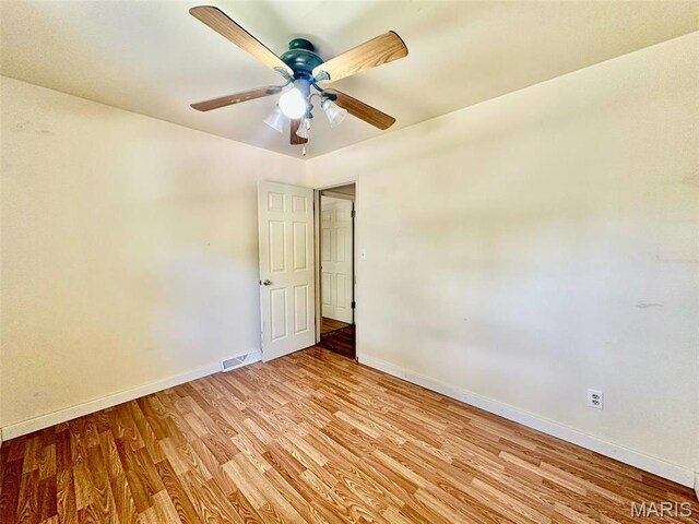 860 Chouteau Ave, Godfrey, IL 62035 - unfurnished room with baseboards, light wood-type flooring, and a ceiling fan