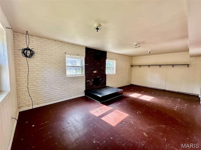 860 Chouteau Ave, Godfrey, IL 62035 - unfurnished living room featuring brick wall and a fireplace