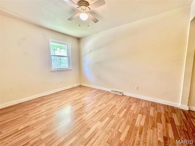 860 Chouteau Ave, Godfrey, IL 62035 - spare room with light wood-style flooring, baseboards, and ceiling fan