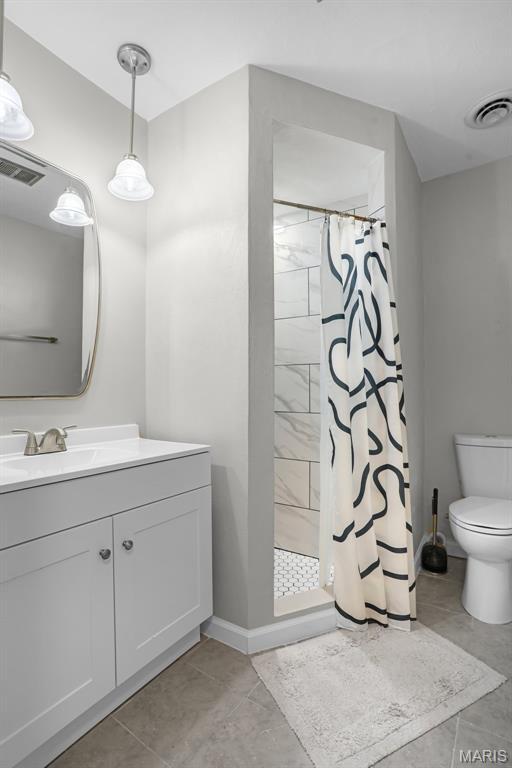 28 French Quarter, Belleville, IL 62223 - bathroom with toilet, a stall shower, and vanity