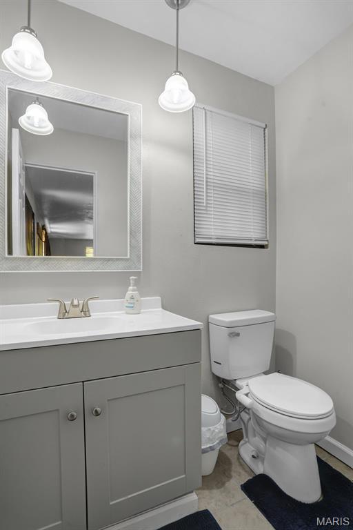 28 French Quarter, Belleville, IL 62223 - bathroom featuring toilet, vanity, and baseboards