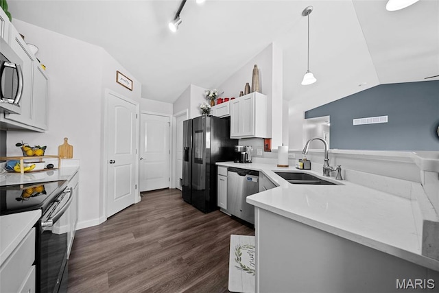 kitchen featuring a sink, black appliances, lofted ceiling, light countertops, and dark wood-style flooring