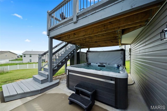 view of patio / terrace featuring a hot tub and stairway
