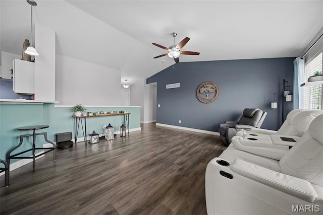 living area featuring lofted ceiling, a ceiling fan, wood finished floors, and baseboards