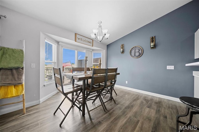 dining area featuring a chandelier, wood finished floors, plenty of natural light, and baseboards