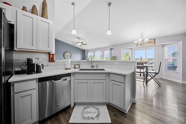 kitchen featuring a sink, a peninsula, dishwasher, gray cabinetry, and a chandelier