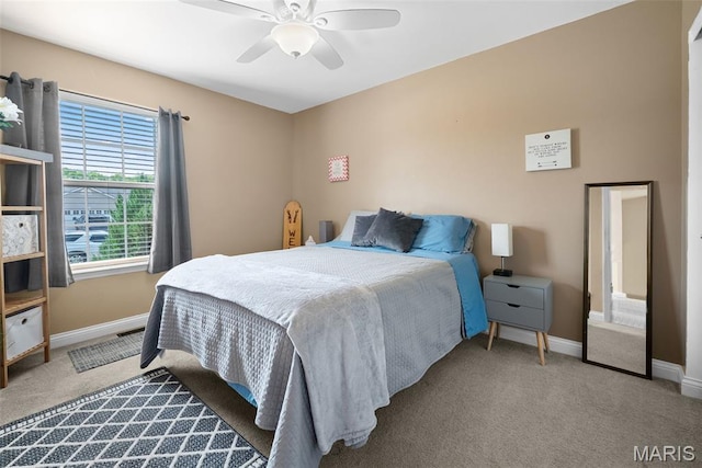 carpeted bedroom with baseboards and a ceiling fan