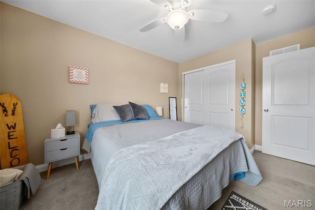 bedroom with carpet floors, a closet, baseboards, and a ceiling fan