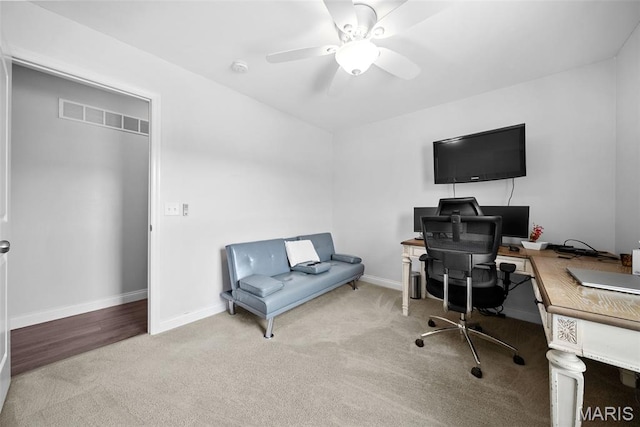 office area with carpet flooring, a ceiling fan, and baseboards