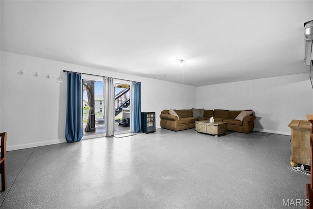 living room featuring baseboards and speckle patterned floor