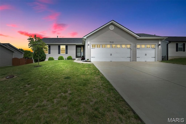 ranch-style home featuring an attached garage, driveway, and a front yard