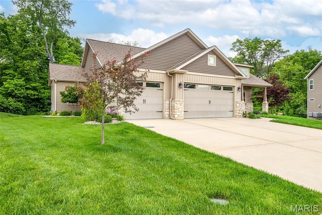 1419 Crimson King Way, Troy, IL 62294 - craftsman-style house with an attached garage, concrete driveway, a front lawn, board and batten siding, and stone siding