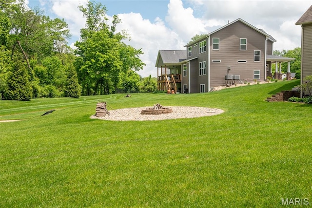 1419 Crimson King Way, Troy, IL 62294 - view of grassy yard featuring an outdoor fire pit and a deck