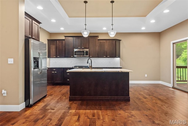 1419 Crimson King Way, Troy, IL 62294 - kitchen featuring stainless steel appliances, a tray ceiling, baseboards, dark brown cabinetry, and a sink