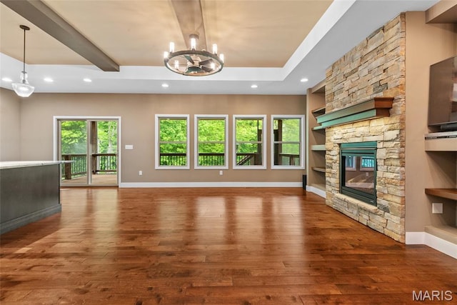 1419 Crimson King Way, Troy, IL 62294 - unfurnished living room with wood-type flooring, a chandelier, a stone fireplace, baseboards, and recessed lighting