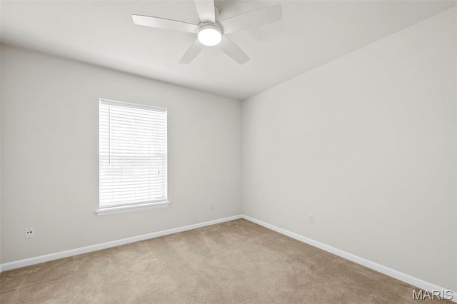 unfurnished room with light colored carpet, baseboards, and ceiling fan