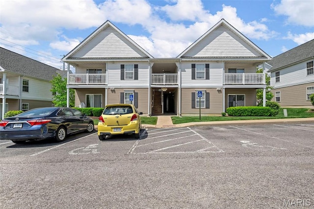 view of building exterior featuring uncovered parking