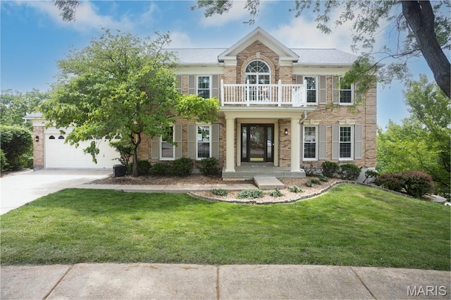712 Carman Oaks Ct, Manchester, MO 63021 - colonial house featuring a balcony, concrete driveway, an attached garage, a front yard, and brick siding