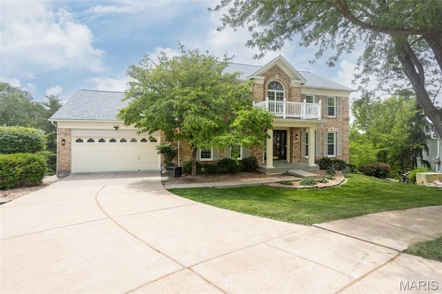 712 Carman Oaks Ct, Manchester, MO 63021 - view of front of house featuring a balcony, a garage, concrete driveway, a front lawn, and brick siding