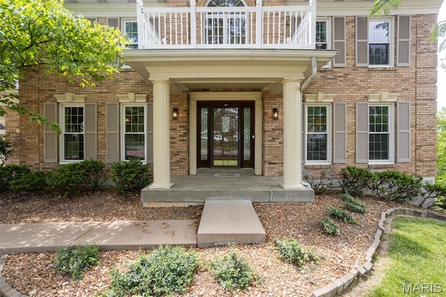 712 Carman Oaks Ct, Manchester, MO 63021 - property entrance featuring a balcony, brick siding, and covered porch
