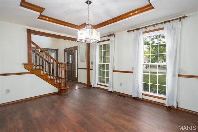 712 Carman Oaks Ct, Manchester, MO 63021 - unfurnished dining area featuring a tray ceiling, wood finished floors, a chandelier, stairs, and baseboards