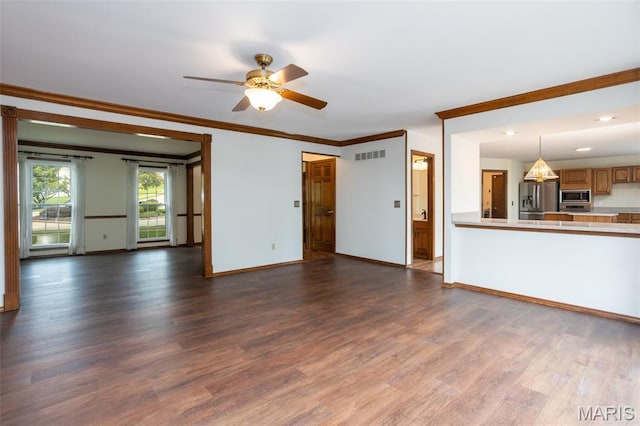 712 Carman Oaks Ct, Manchester, MO 63021 - unfurnished living room featuring dark wood-type flooring, crown molding, a ceiling fan, baseboards, and recessed lighting