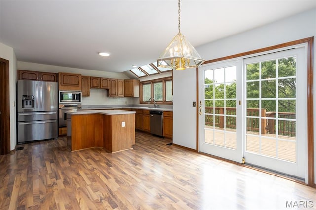 712 Carman Oaks Ct, Manchester, MO 63021 - kitchen with stainless steel appliances, light countertops, a chandelier, a center island, and tasteful backsplash