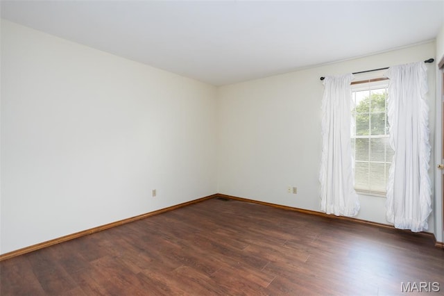 712 Carman Oaks Ct, Manchester, MO 63021 - spare room featuring dark wood-style flooring and baseboards