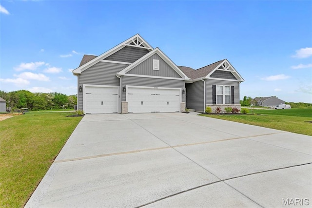 craftsman inspired home with a front lawn, an attached garage, concrete driveway, board and batten siding, and stone siding